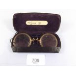 A pair of gold and horn rimmed spectacles - cased