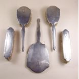 A five piece silver brush and mirror set