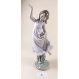 A Lladro figure of a girl throwing flowers - boxed 'Garden Dance'