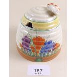 A Clarice Cliff crocus pattern honey pot with bee finial painted in the crocus pattern