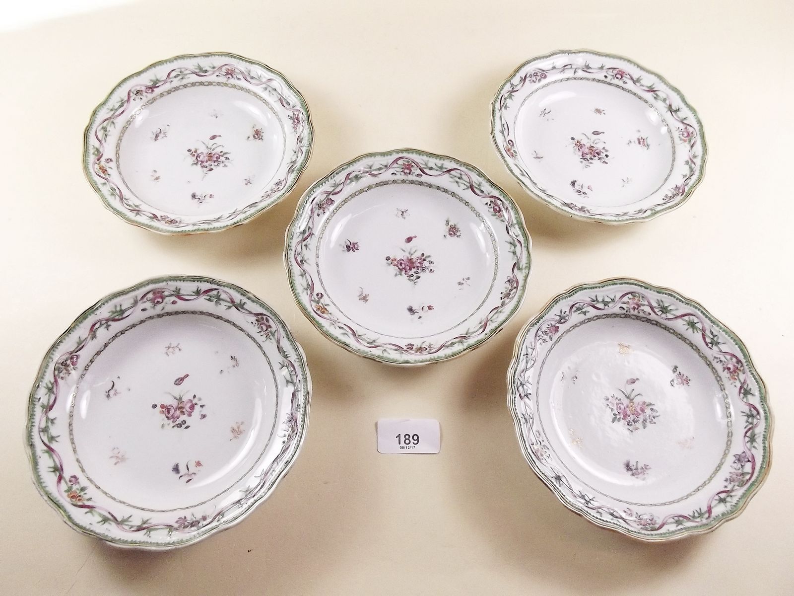 Five small 18th century Chinese famille rose dishes painted ribbons and flowers in European
