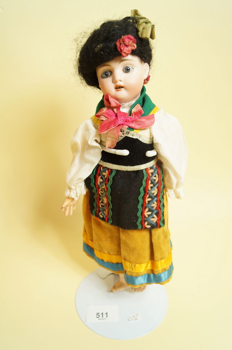 A German bisque head doll in European National costume marked 478, 27cm