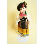 A German bisque head doll in European National costume marked 478, 27cm
