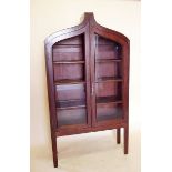 A 19th century mahogany display cabinet with arch top over two glazed doors (one with glass a/f)