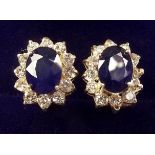 A pair of 14 carat gold diamond sapphire cluster earrings