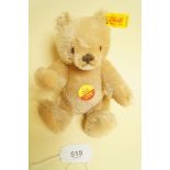 A small Steiff gold plush bear