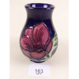 A Moorcroft vase painted anemone on a deep blue ground - 10cm