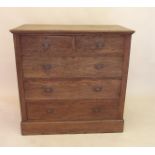 An Edwardian oak chest of two short and three long drawers