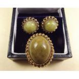 A 9 carat gold ring set green agate and a pair of matching earrings