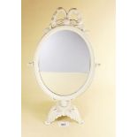 An oval dressing table mirror