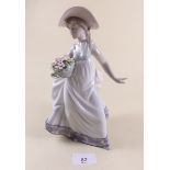 A Lladro figure of a girl with flowers - boxed 'Carefree'