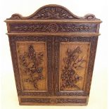 A Victorian key cupboard with carved bird and tree decoration to door - 45cm wide x 14cm deep x 48cm