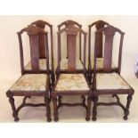 A set of six oak arch back dining chairs with carved stretcher
