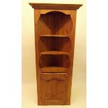 A modern pine corner cabinet