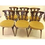 A set of six Ercol dining chairs with carved backs
