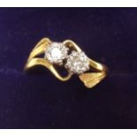 An 18 carat gold and platinum set diamond crossover ring - size N