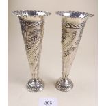A pair of silver tapered vases with embossed floral decoration, London 1897/8 by W. Comyn, 16.5cm