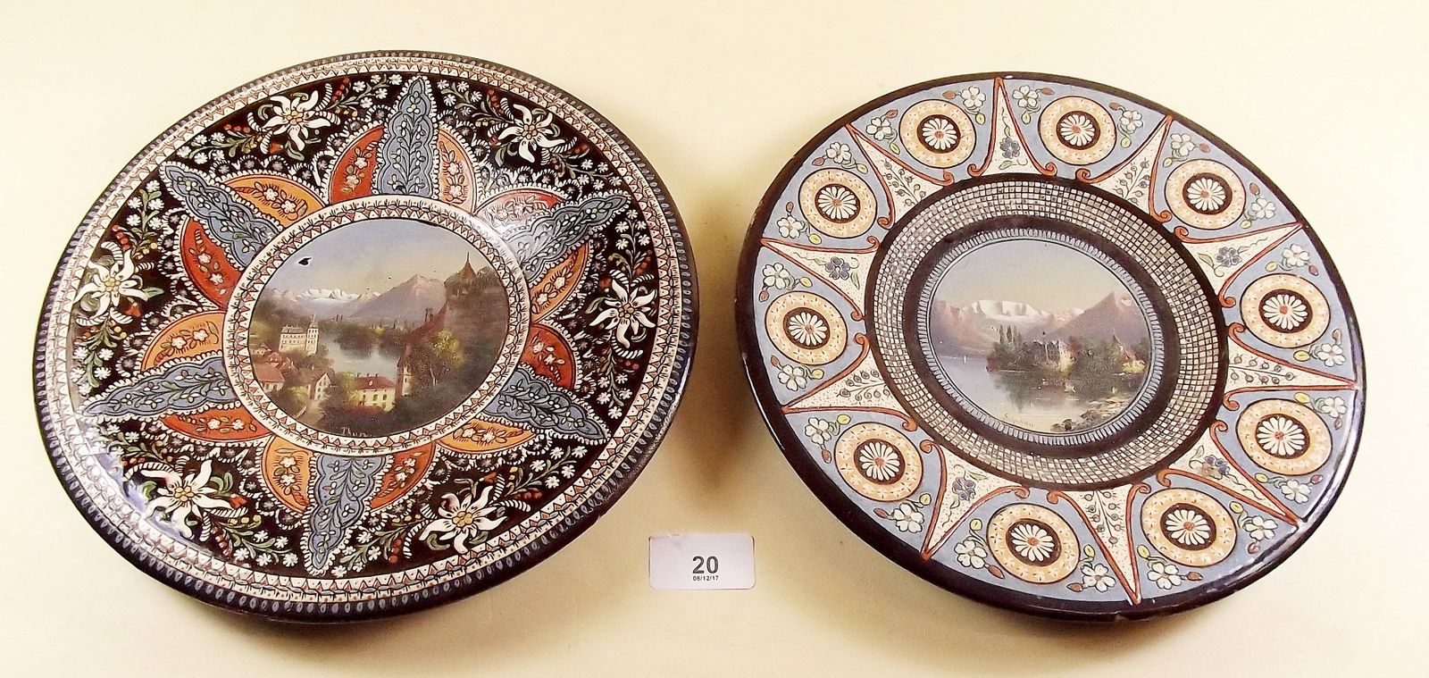 Two Thoune plates painted Alpine landscapes within stylised floral borders - 25cm dia