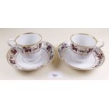 A pair of coffee cups and saucers painted vines in gilt and brown c1800