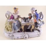 A large porcelain group in 18th century style lady and gent playing chess - 35cm