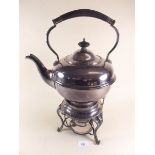 A large silver plated tea kettle on stand