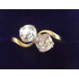 A fine 18 carat gold and platinum set large diamond crossover ring - each stone approx. one carat,