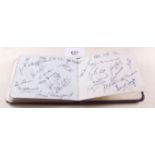 An autograph book with a variety of signatures including Jack Warner, the team of Stoke City