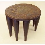 An African carved hardwood tribal stool - one leg deficient