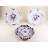 A Faience plate and a pair of Boch plates painted flowers