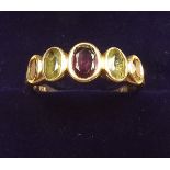 An 18 carat gold ring set peridot, citrine and amethyst, size O