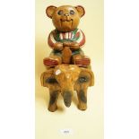 A carved wooden teddy on an elephant, 32cm high