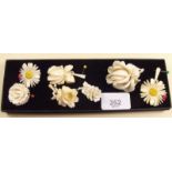 Three Victorian carved ivory flower form brooches and four similar pendants