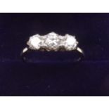 A platinum set three stone diamond ring, size M
