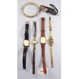 A group of five various ladies wrist watches and a gold plated bangle