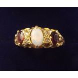 An 18 carat gold opal, garnet and diamond set ring, size P