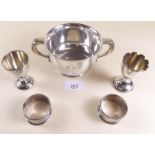 A silver two handled porringer - Birmingham 1922, 118g, two silver eggcups and two napkin rings (