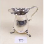 A silver cream jug on three pad feet Birmingham 1897