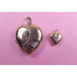 A 9 carat gold heart form locket and miniature heart pendant or charm