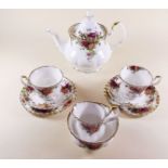 A Royal Albert tea service comprising: teapot, six cups and saucers, two jugs, six tea plates and