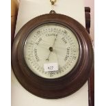 An oak framed aneroid barometer 28cm diameter