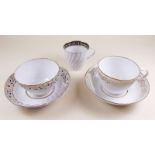 An early 19th century tea cup and tea bowl with saucers with gilt border decoration - possibly