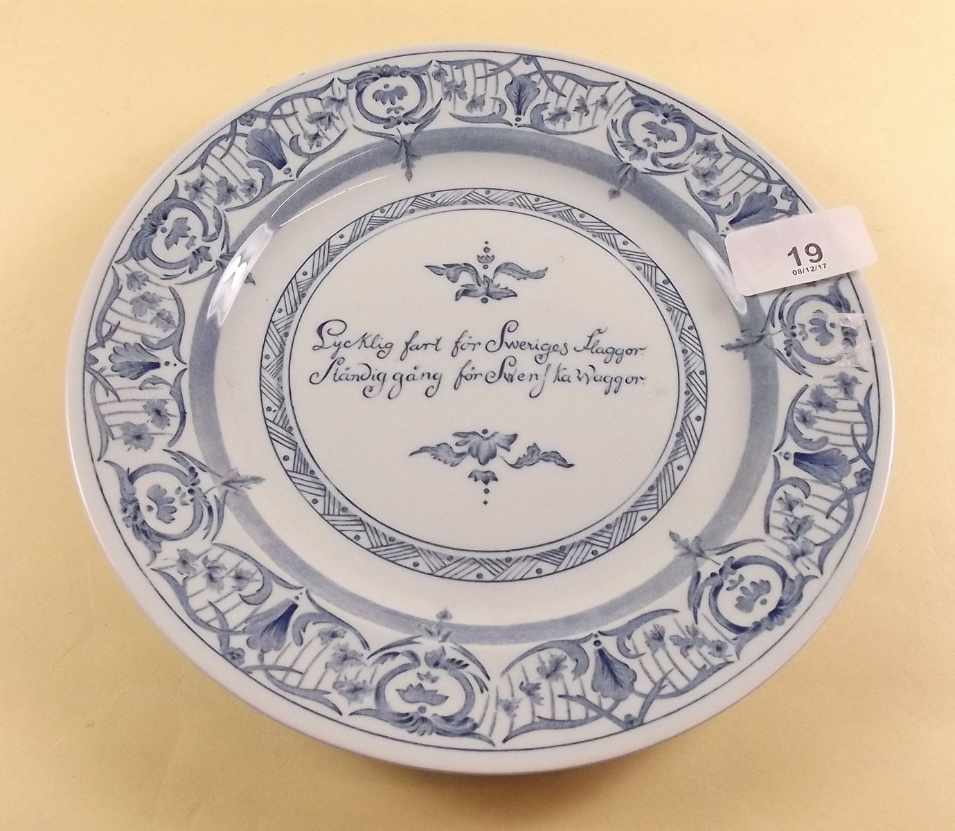 A Rorstrand blue and white plate with silver disc mounted to back