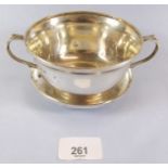A silver two handled porringer and saucer - Birmingham 1915, 248g