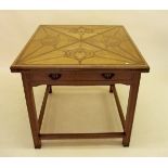 An Edwardian satinwood and walnut marquetry envelope card table of Art Nouveau design with frieze