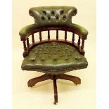 A green upholstered swivel desk chair