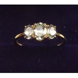 A 9K gold green tanzanite three stone ring, size O and a half