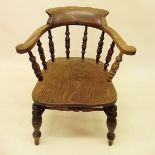 An early 20th century elm seated smokers bow chair