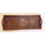 An Arts and Crafts oak tray with carved floral decoration, 63 x 24cm