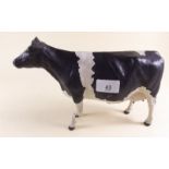 A porcelain cow by Harper Shebeg Isle of Man - 28cm long - two legs a/f