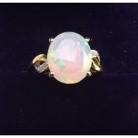 A 9K gold Ethiopian opal ring on diamond set shoulders, size L